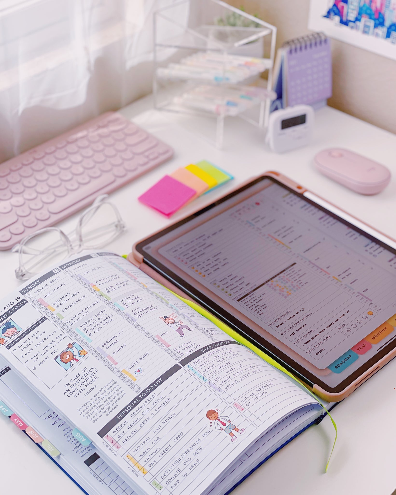 A digital and paper planner laying on a desk